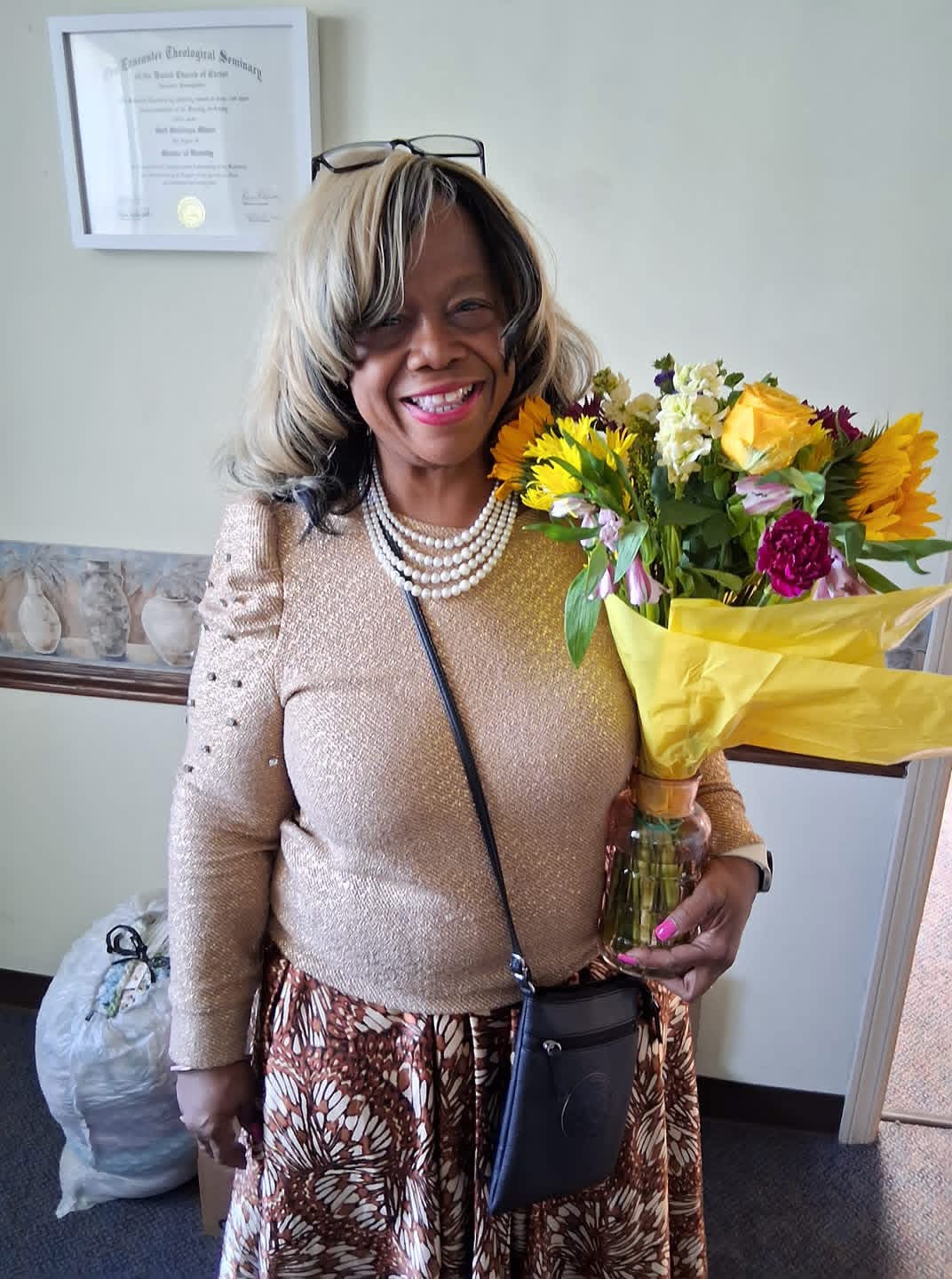 Pastor Gail Stallings holding a bouquet of flowers